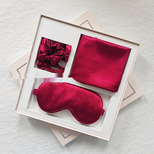 Silk-style sleep gift set with eye mask, pillowcase, and headbands in champagne